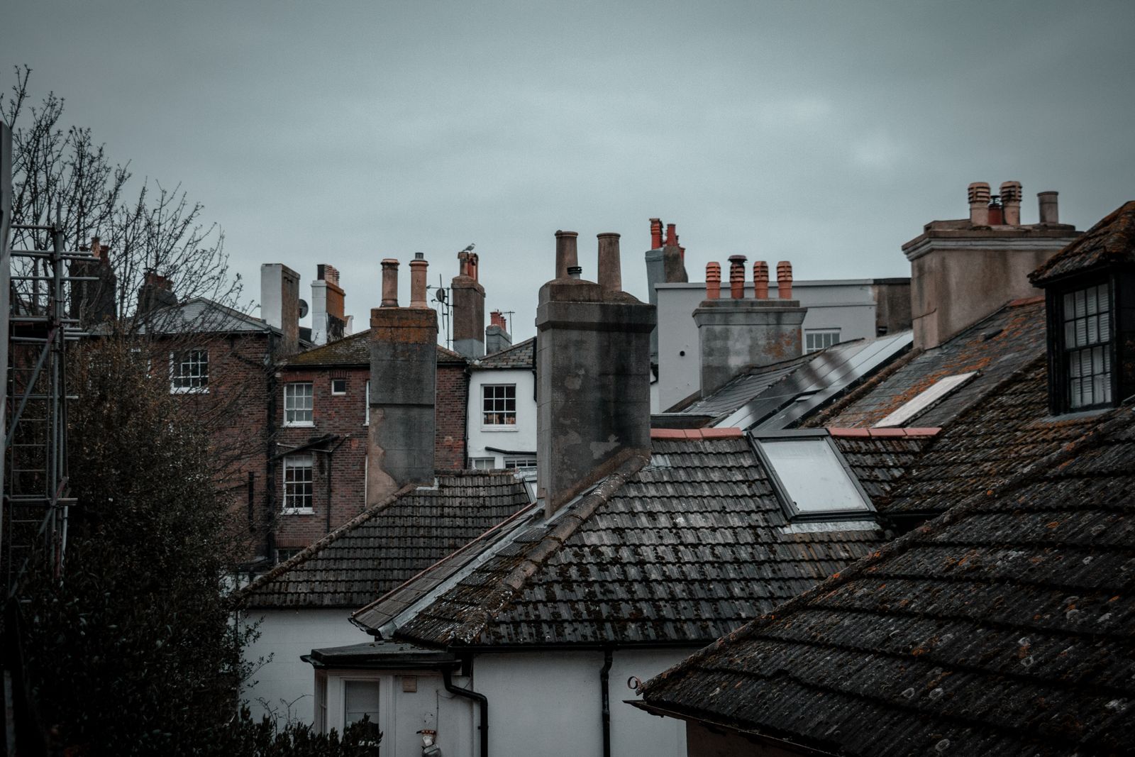 Brick chimney stacks above rooftops