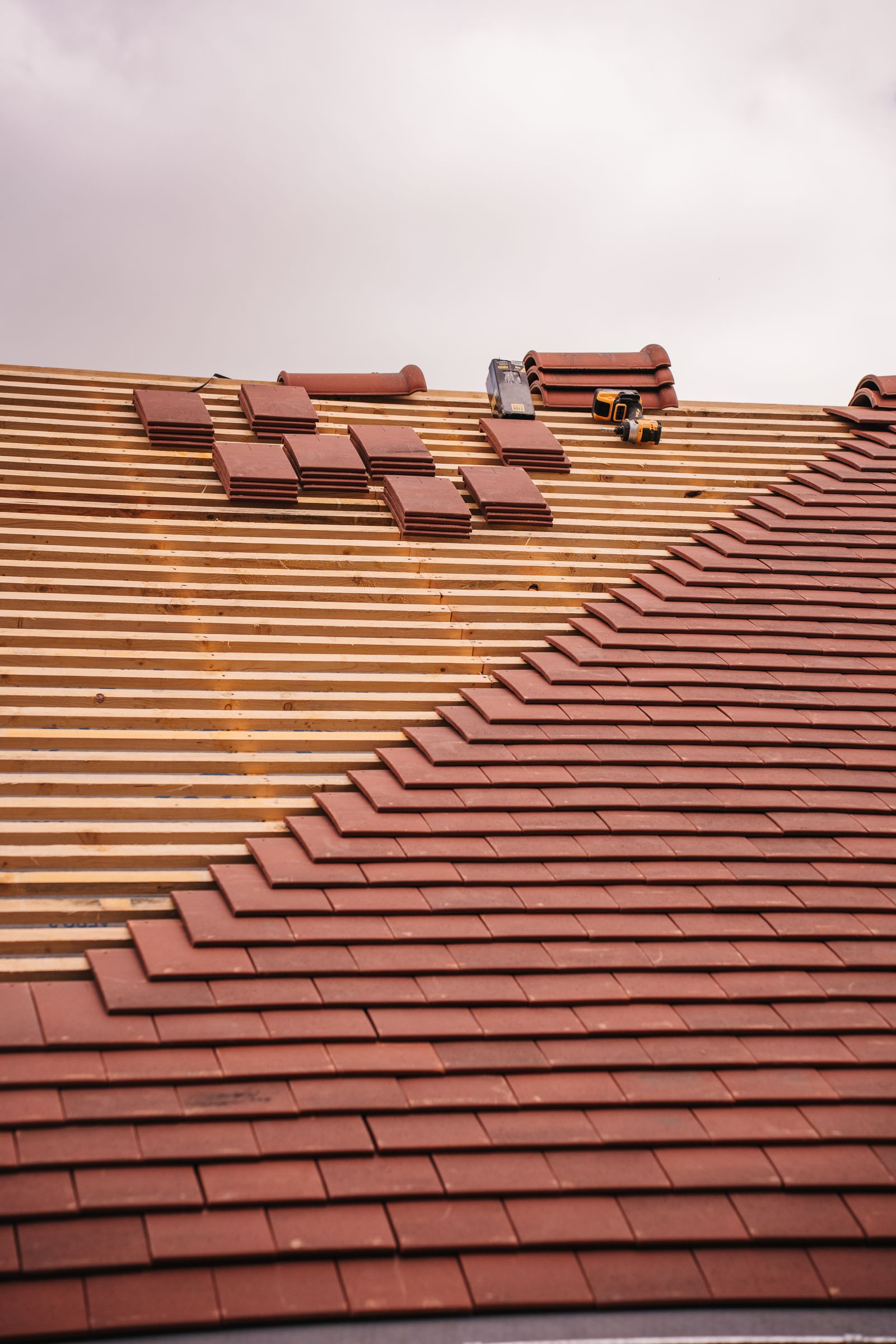 New roof being tiled on fresh battens