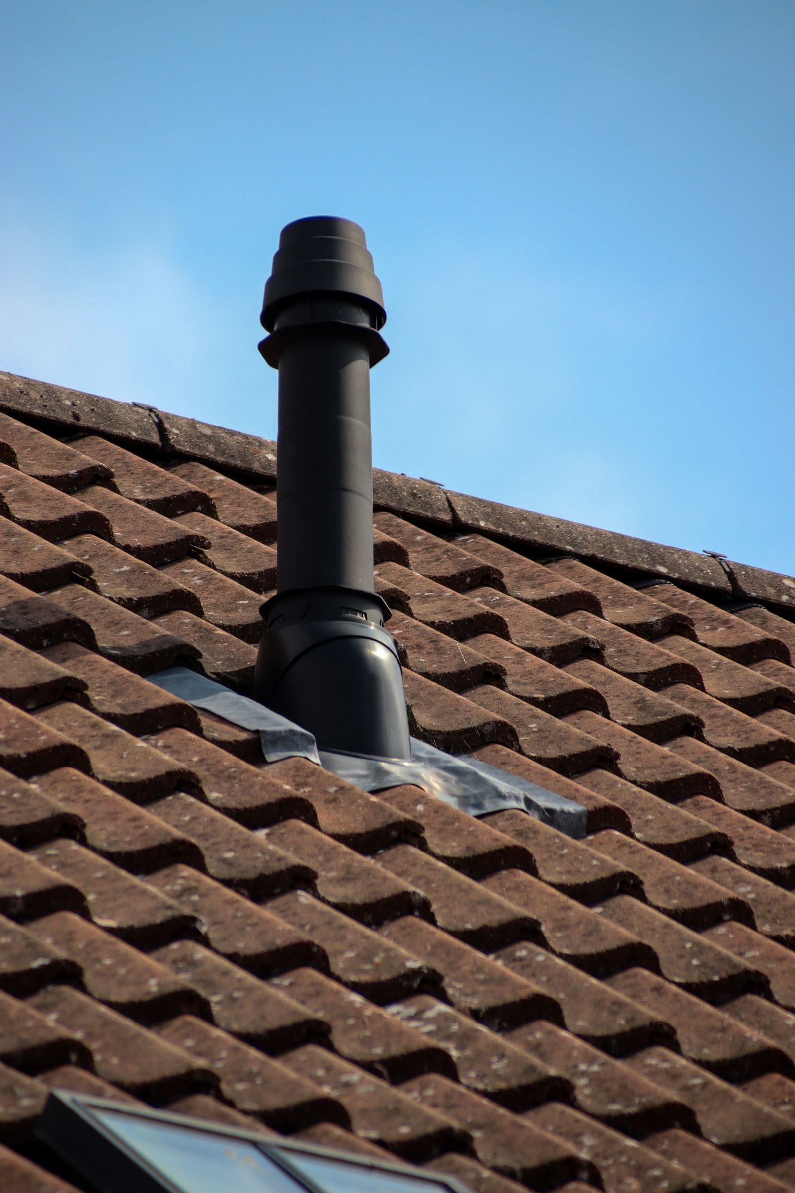Tiled roof with flue and lead flashing